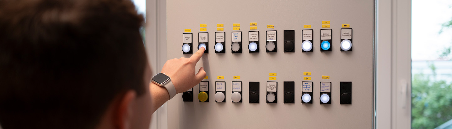 Employee presses a button on a switch cabinet