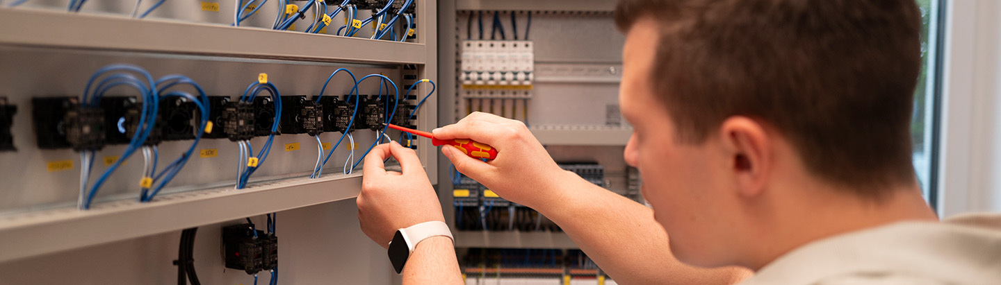 Employee works on a control cabinet